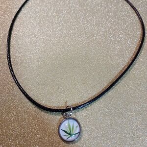 Elegant Black Necklace with Green Leaf Pendant